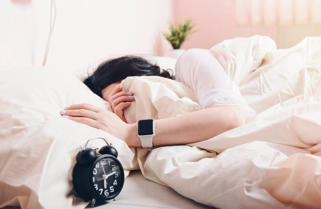 How to Track Your Sleep on an Apple Watch A person sleeps while wearing an apple watch