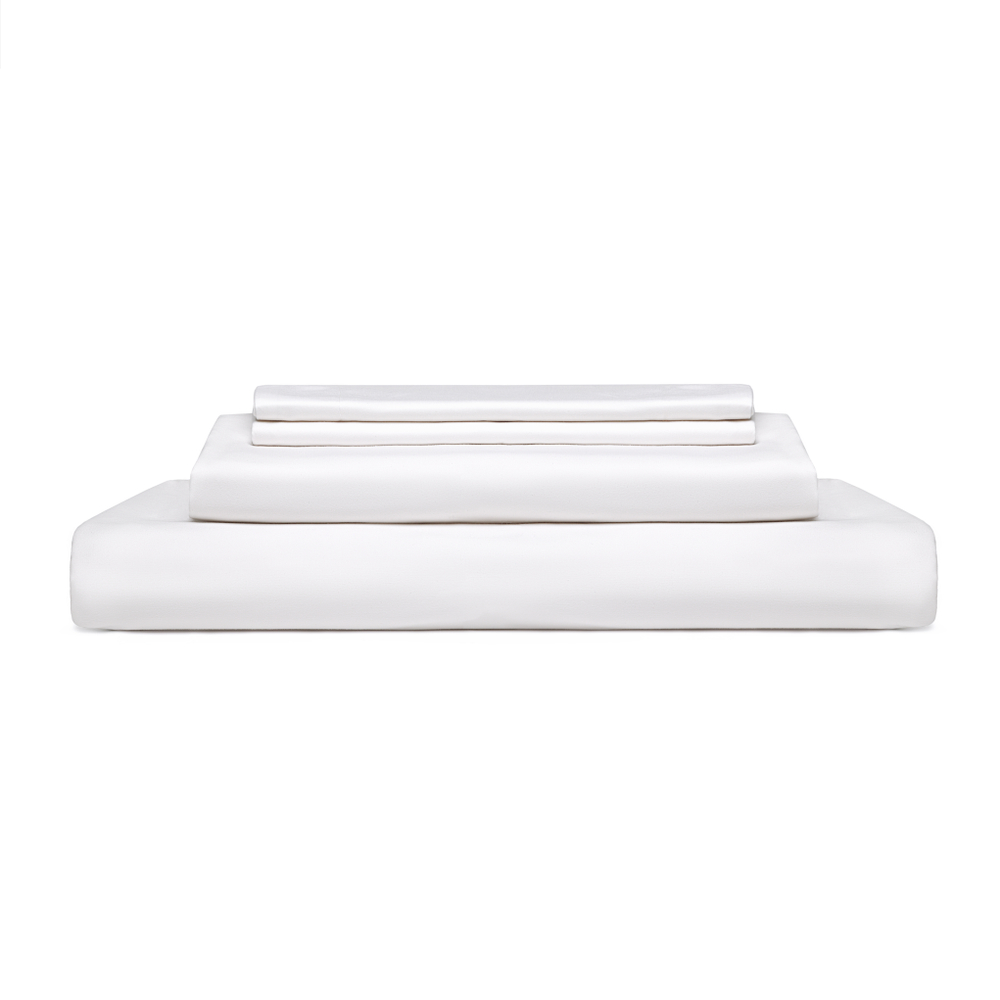 Linen vs. Cotton Sheets Stack of folded white sheets isolated with a white background