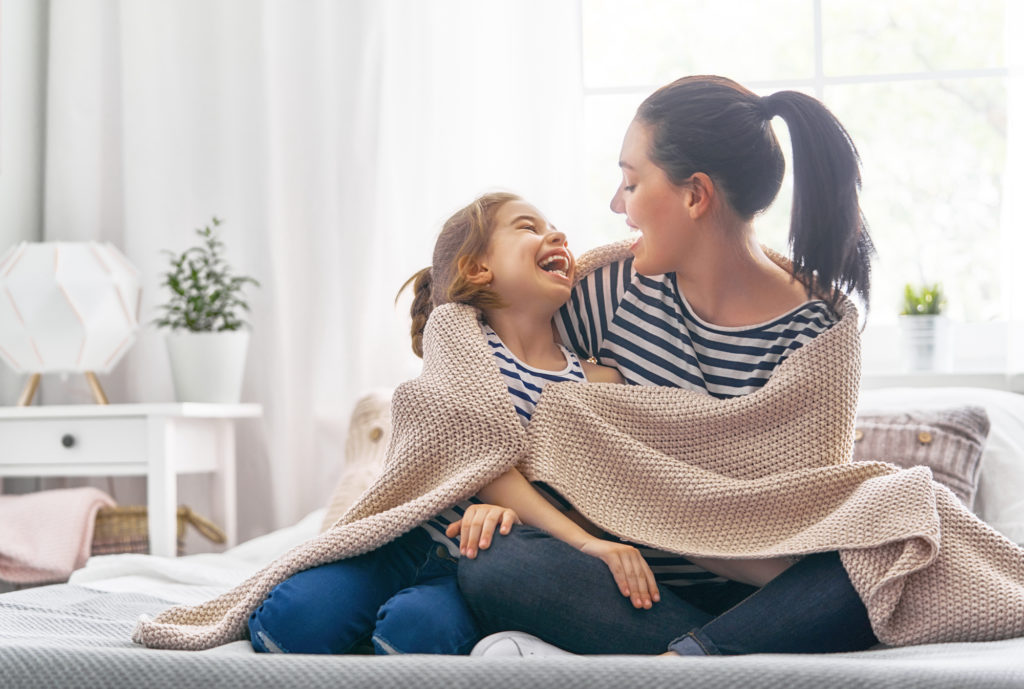 What Is a Coverlet? Woman and child under coverlet